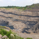 An opencast mine in Jharia that involves the extraction of coal through an open pit or borrow contributes to environment pollution in the region.